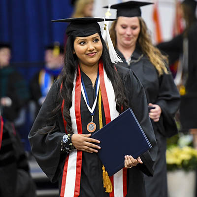 A graduate smiles widely during the ceremony