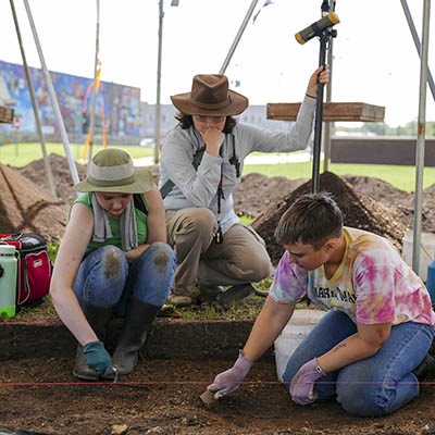 Students work at an archaeology dig site as part of their anthropology studies.