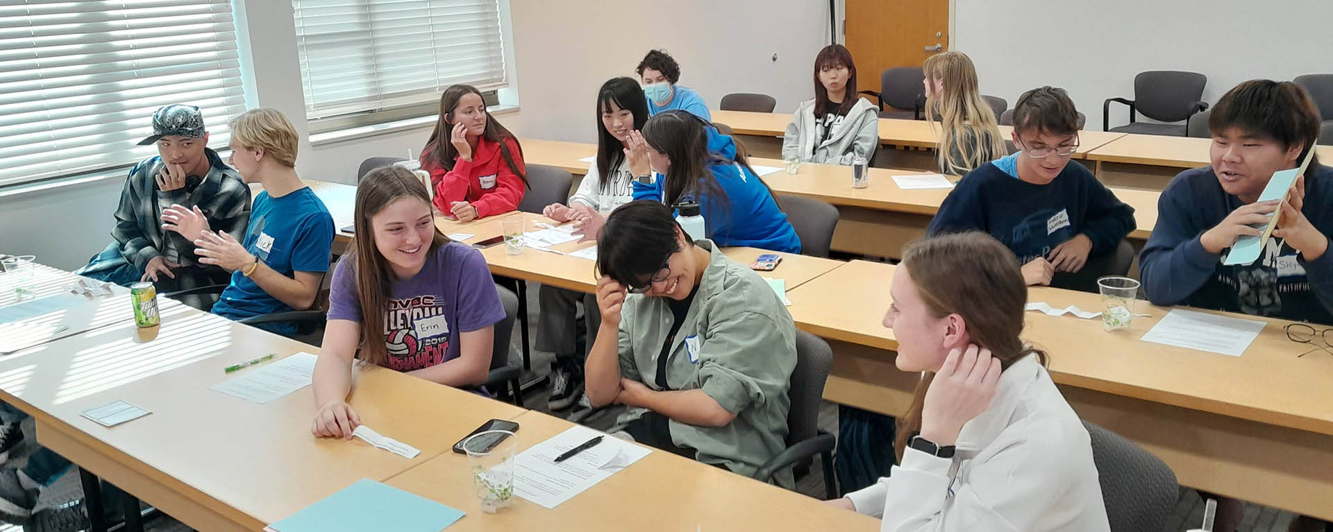 Students smile during a class group discussion.
