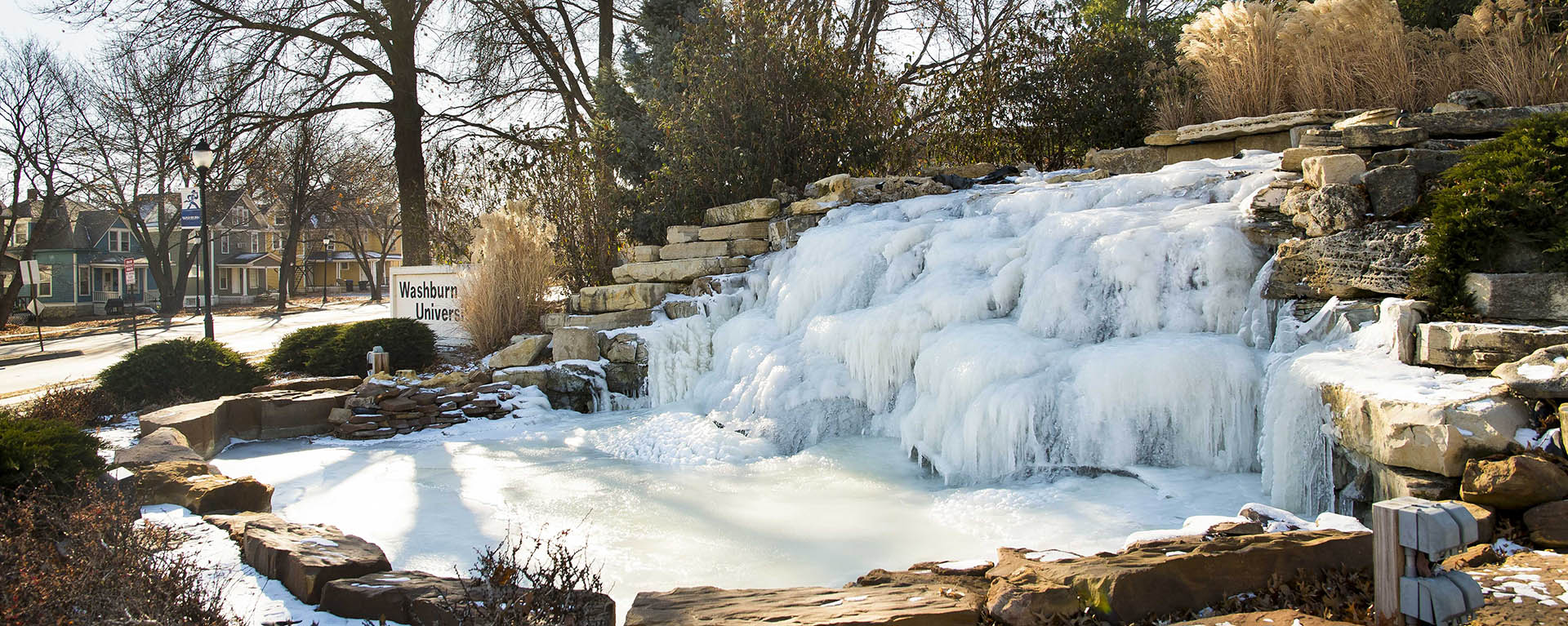 Washburn sign and waterfall in snow