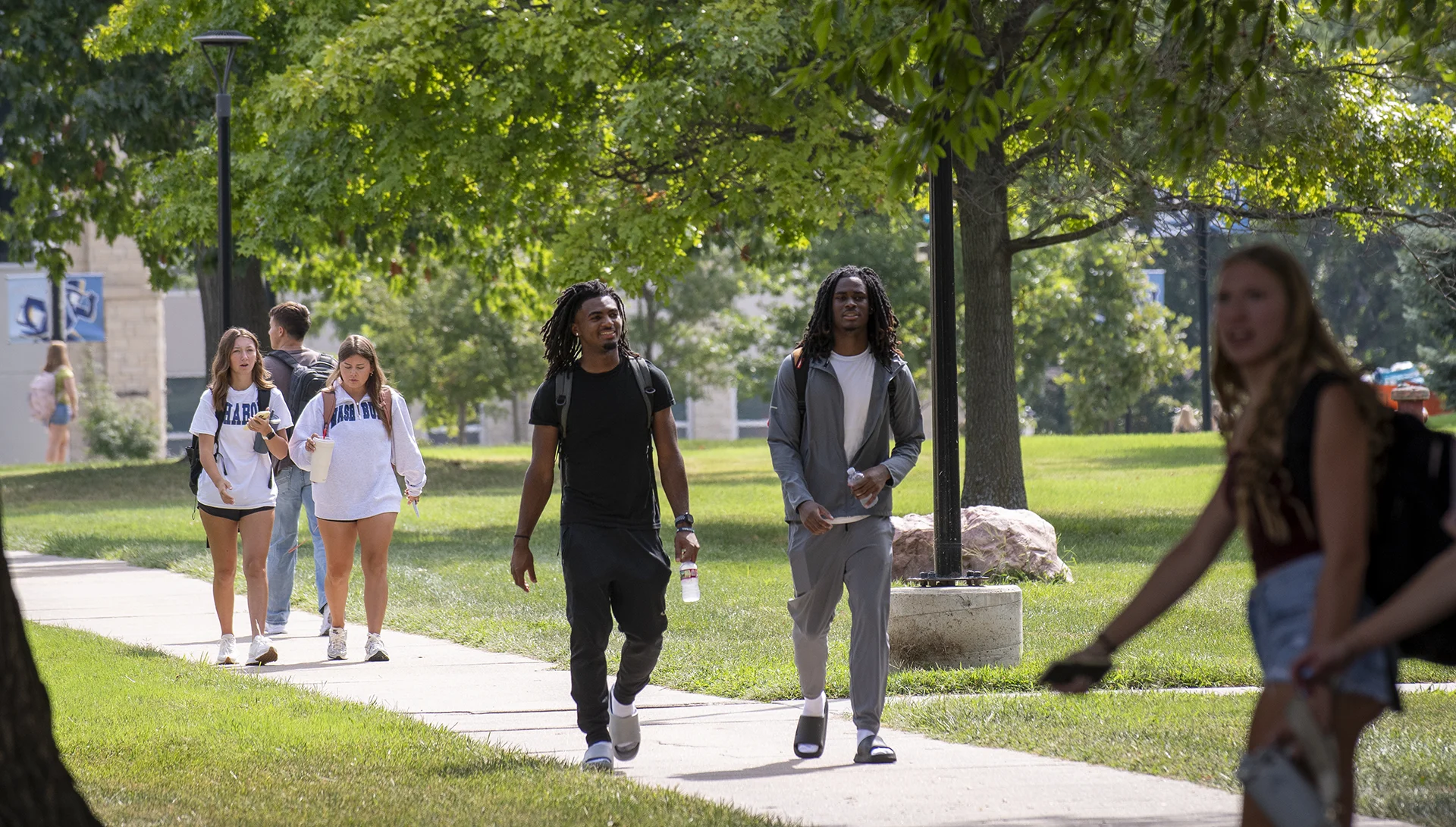 Students smile while walking to class.