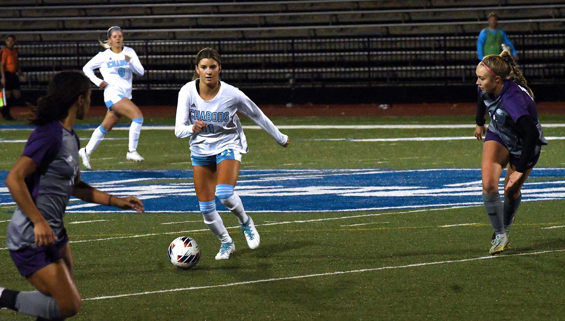Washburn women's soccer team in action during night game