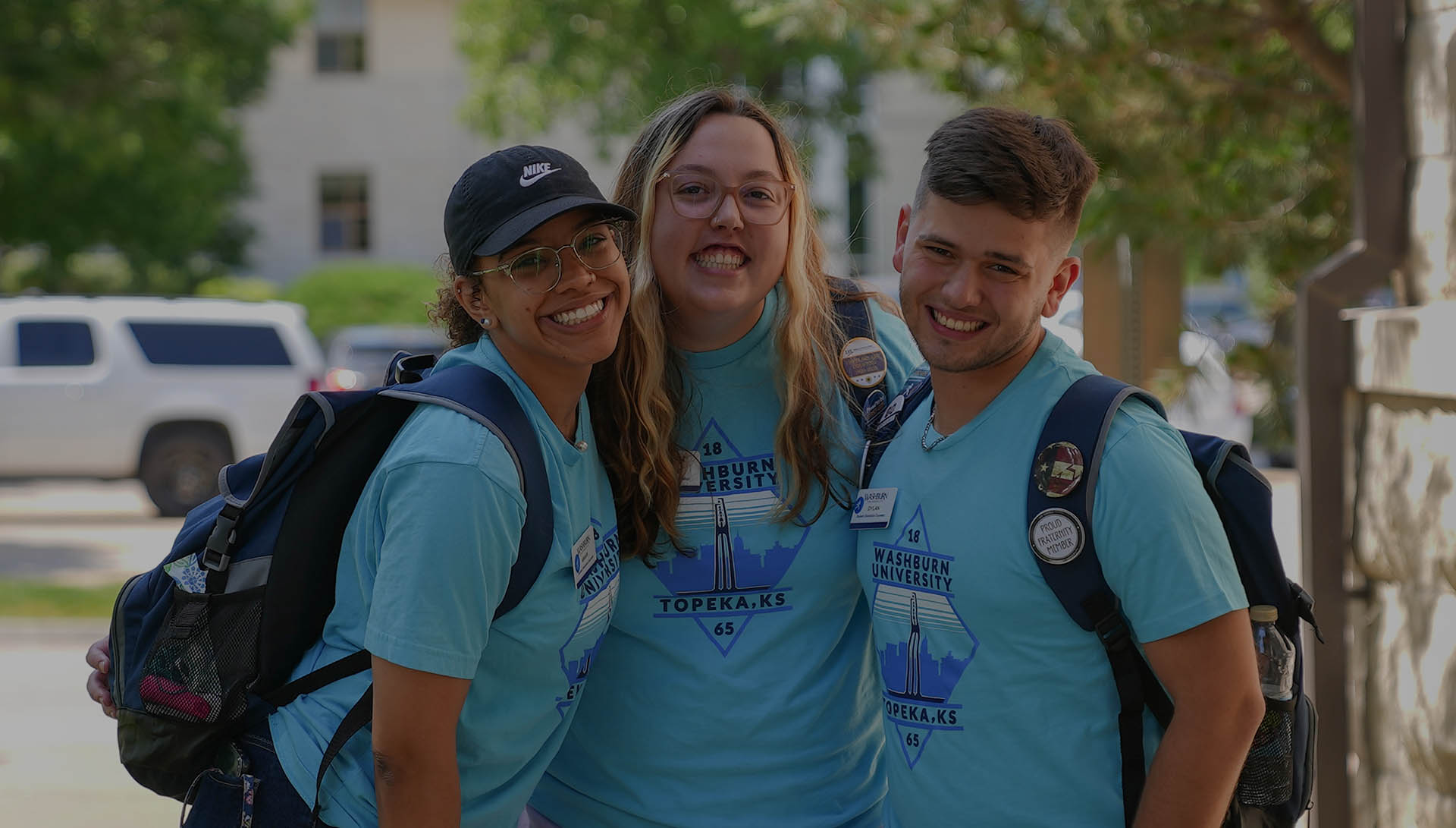 Three Washburn students smile.