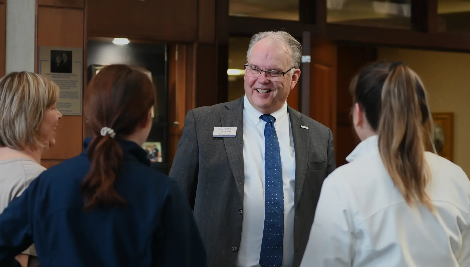 Provost John Fritch talking with employees during a meet and greet.