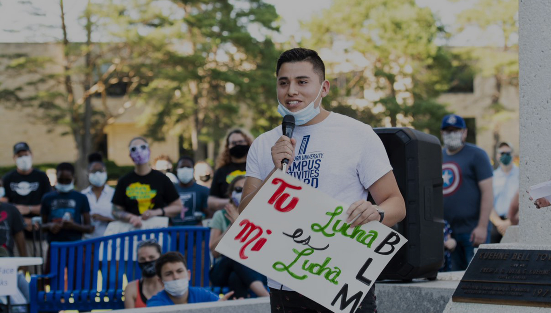 WU Student speaking to gathering with masks on outdoors