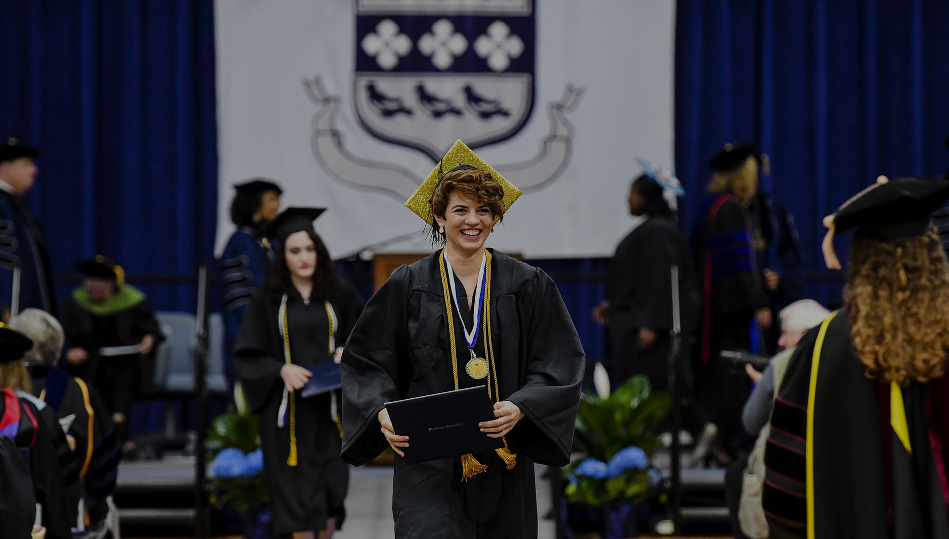 female student smiling at graduation