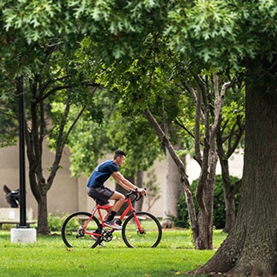 Student biking on campus