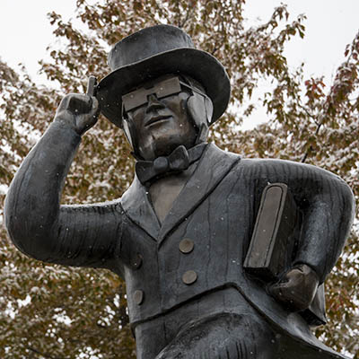 Ichabod statue with snow falling.