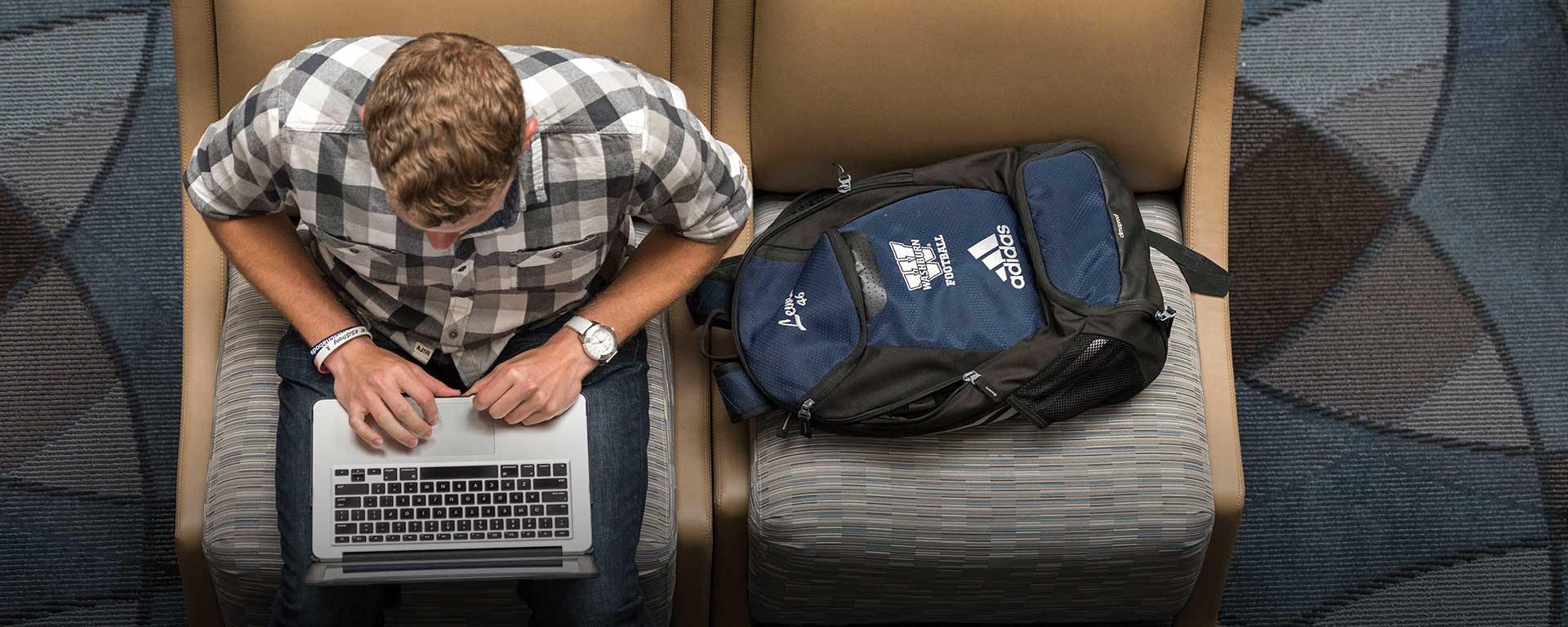male student on a laptop