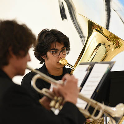 A student plays a tuba during a performance for Apeiron.