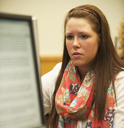 A Washburn student focuses on an assignment during class