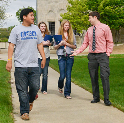 An admissions counselors takes three prospective students on a tour of Washburn's campus
