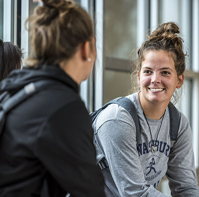 A student smiles while wearing a Washburn shirt.