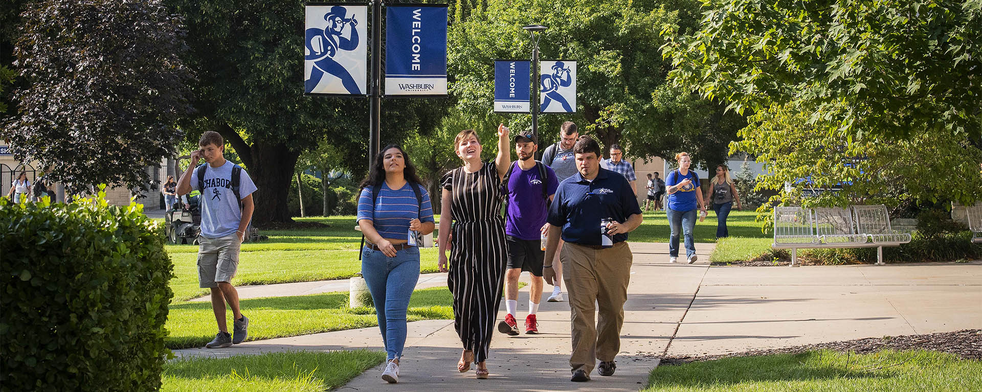 Students are shown around on campus on a sunny day