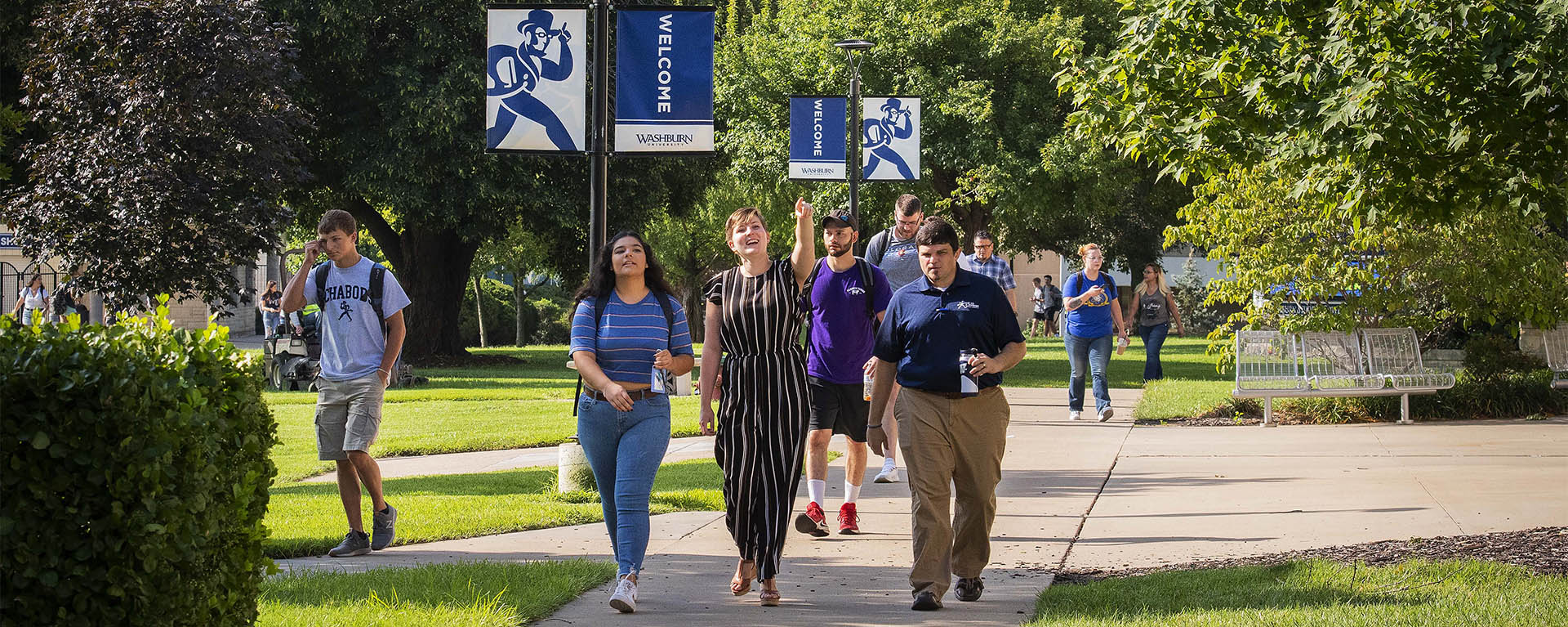 Students are shown around on campus on a sunny day