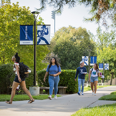 Students chat while walking to class on a spring day.