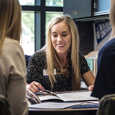 Christa meeting with a student and parents