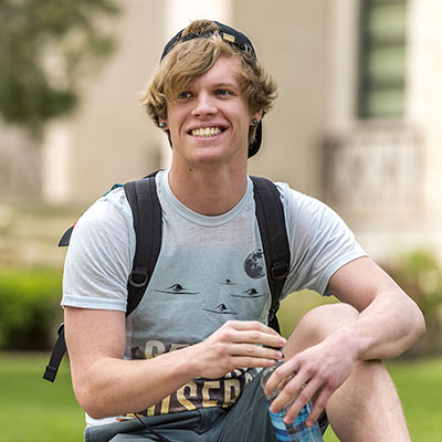 A Washburn student smiles on campus