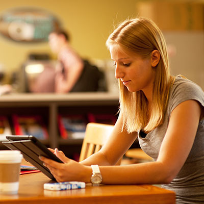 A Washburn student reads her tablet in the Memorial Union.