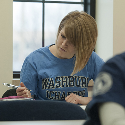 A Washburn student takes notes during a School of Nursing class