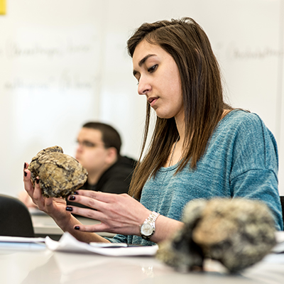 A student looks a a skull during a forensics class