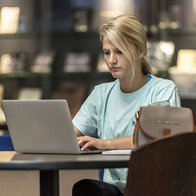 A student studies in the Welcome Center of Morgan Hall.
