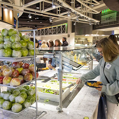 A student chooses and item from the salad bar in Lincoln Dinning.