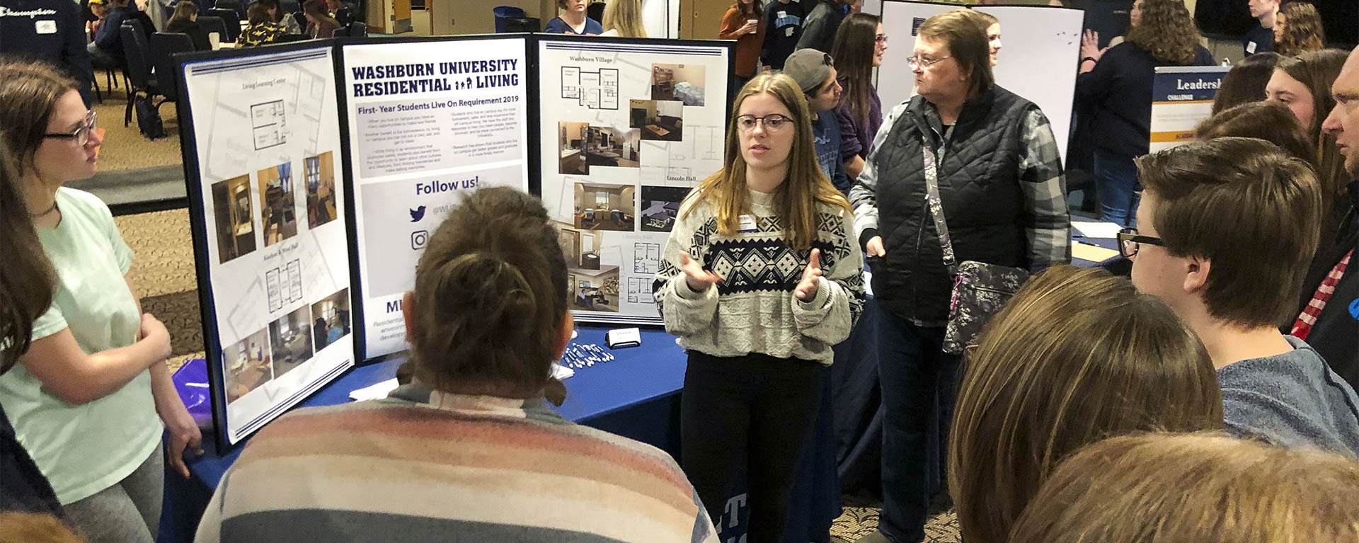 A student talks about options to live on campus during a resource fair at an Ichabod Day.