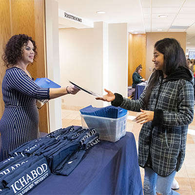 A student smiles while being welcomed to an Ichabod Day.