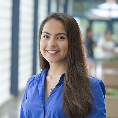 A Washburn students smiles while standing in Bennett Computer Center