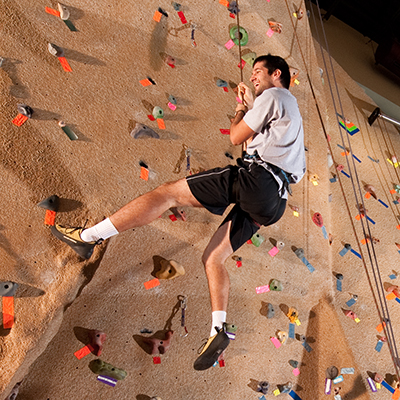A Washburn student climbs the wall in the Student Recreation and Wellness Center.