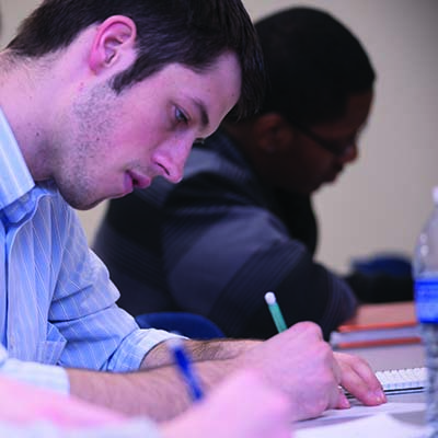 A Washburn student takes notes during a class in Henderson Learning Center.
