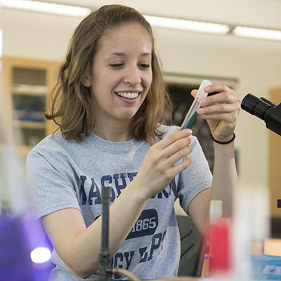 A Washburn student checks a test tube during a biology class in Stoffer Science Hall.