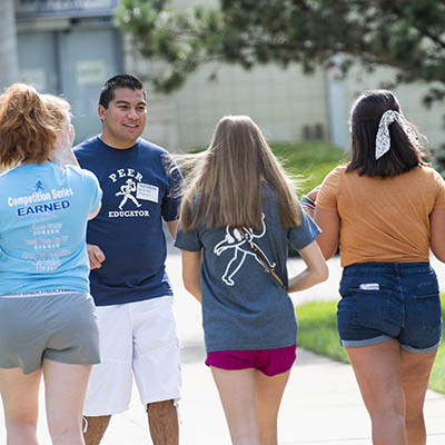 A peer educator leads a tour on campus