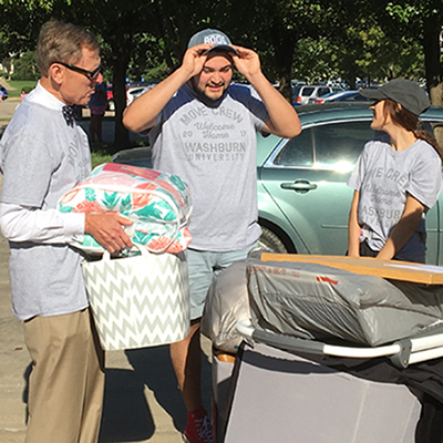 President Jerry Farley and Washburn student welcome and help new students during Move-In Day