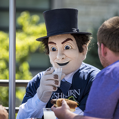 Mr. Ichabod interacts with a student during Welcome Week