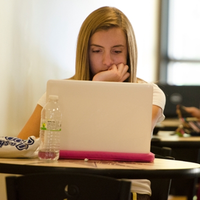 A Washburn students works on her laptop