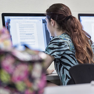 A student works on an assignment during a mass media course at Washburn.