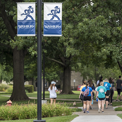 Students walk across campus between classes at Washburn.