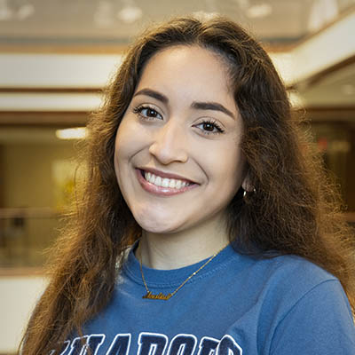 Washburn Summer Orientation Counselor Analisa smiles while wearing a Washburn shirt