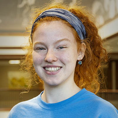 Washburn Summer Orientation Counselor Chloe smiles while wearing a Washburn shirt