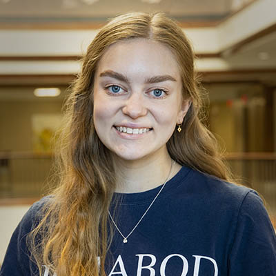 Washburn Summer Orientation Counselor Hannah smiles while wearing a Washburn shirt