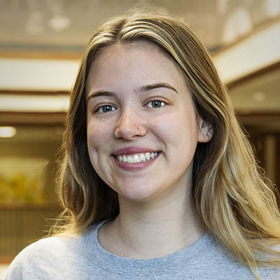 Washburn Summer Orientation Counselor Katherine smiles while wearing a Washburn shirt