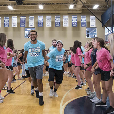 Students laugh while running at playfair