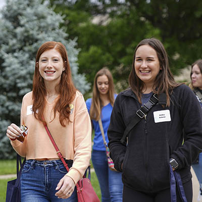 An orientation counselor smiles while on a tour during orientation.