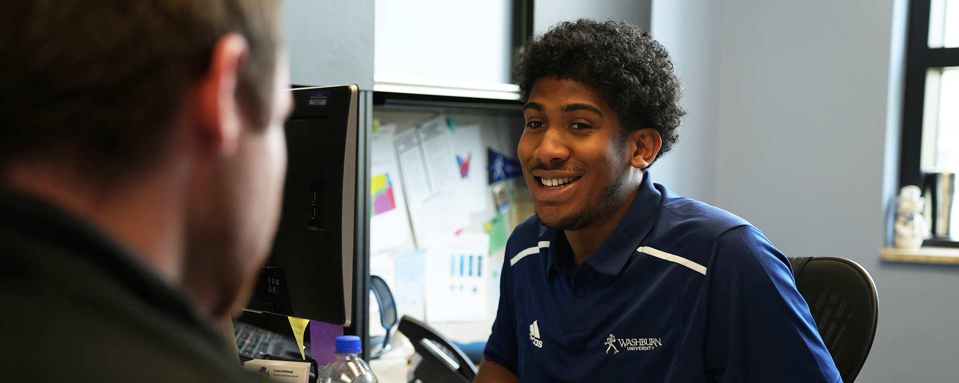 A Washburn admissions counselor meets with a prospective student in the Welcome Center.