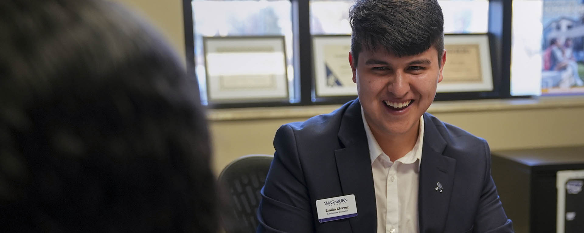 A Washburn admissions counselor meets with a prospective student in the Welcome Center.