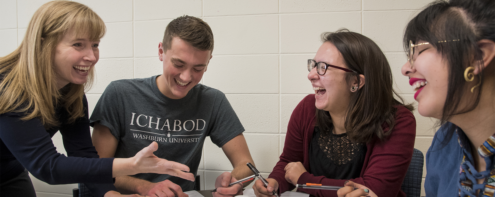 An instructor works with students during a Washburn course.