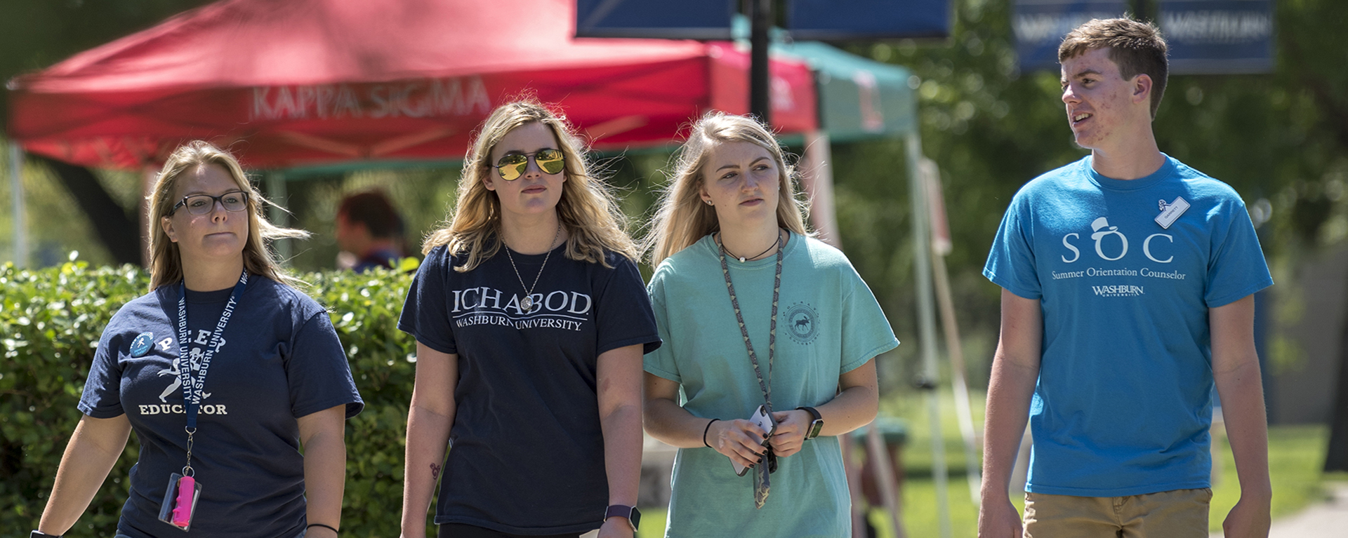 Washburn Summer Orientation Counselors and peer educators walk across campus