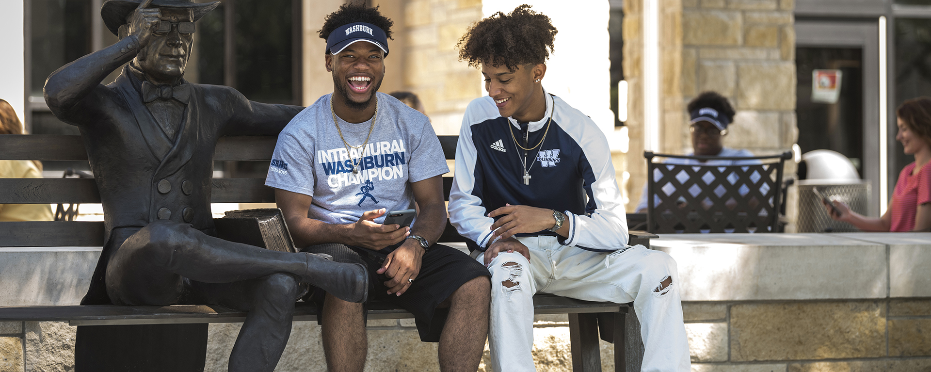 Washburn students take a selfie together in front of the Welcome Center